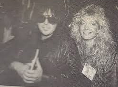 A picture of Mick Mars and Emi Canyn.